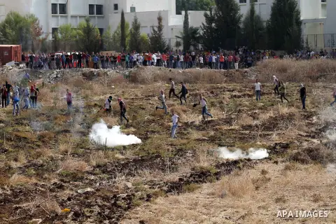 Palestinian protesters throw stones at Israeli security forces during clashes in the West Bank town of Tulkarm, October 20, 2015. Triggered by Israeli incursions into the Al-Aqsa Mosque compound last month, violence and...
