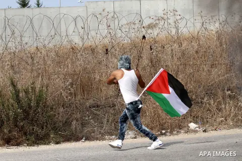 A Palestinian protester uses a sling shot to throw stones at Israeli security forces during clashes in the West Bank town of Tulkarm, October 20, 2015. Triggered by Israeli incursions into the Al-Aqsa Mosque compound las...