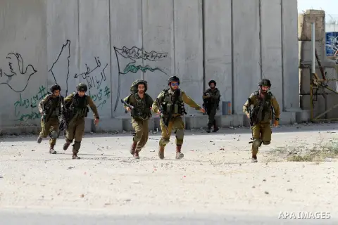 Israeli soldiers run after Palestinian protesters during clashes in the West Bank town of Tulkarm, October 20, 2015. Triggered by Israeli incursions into the Al-Aqsa Mosque compound last month, violence and protests agai...