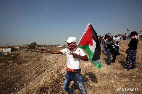 A Palestinian protester uses a sling shot to throw stones at Israeli security forces during clashes in the West Bank town of Tulkarm, October 20, 2015. Triggered by Israeli incursions into the Al-Aqsa Mosque compound las...