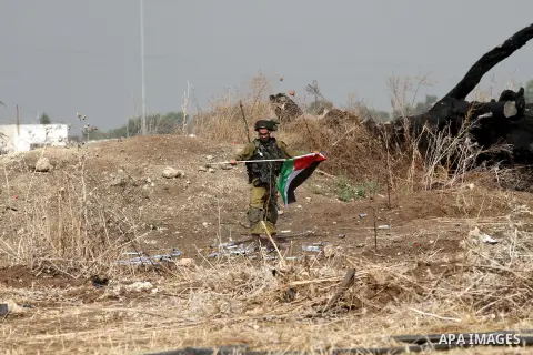 An Israeli soldier remove a Palestinian flag during clashes with Palestinian protesters in the West Bank town of Tulkarm, October 20, 2015. Triggered by Israeli incursions into the Al-Aqsa Mosque compound last month, vio...