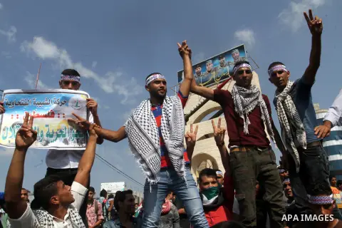 Palestinian youths hold knives in front of a mock Qassam rocket during an anti-Israeli protest in Rafah n the southern Gaza Strip, October 20, 2015. Triggered by Israeli incursions into the Al-Aqsa Mosque compound last m...