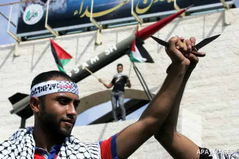 Palestinian youths hold knives in front of a mock Qassam rocket during an anti-Israeli protest in Rafah n the southern Gaza Strip, October 20, 2015. Triggered by Israeli incursions into the Al-Aqsa Mosque compound last m...