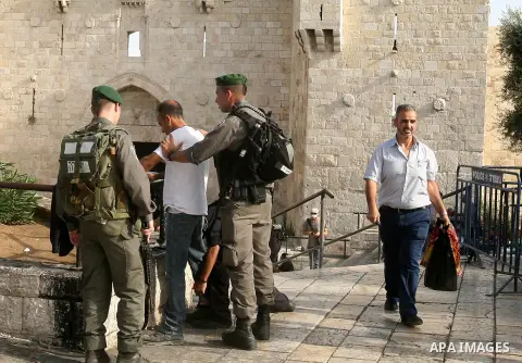 An Israeli police guard Israeli border checks a Palestinian man at Damascus gate in Jerusalem's Old City on October 22, 2015. U.S. Secretary of State John Kerry on Thursday expressed a "cautious measure of optimism" foll...