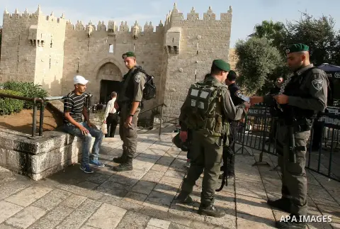An Israeli police guard Israeli border checks a Palestinian man at Damascus gate in Jerusalem's Old City on October 22, 2015. U.S. Secretary of State John Kerry on Thursday expressed a "cautious measure of optimism" foll...