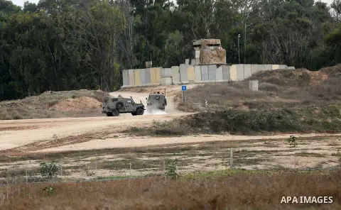 Israeli security forces take position during clashes with Palestinian protesters near the border between Israeli and central Gaza Strip, on October 23, 2015. Palestinian factions called for mass rallies against Israel in...