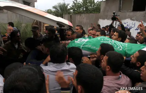 Palestinian men carry the body of Khalil Obied, who died of wounds suffered during clashes with Israeli forces, during his funeral in Khan Yunis, in the southern Gaza Strip, on October 25, 2015. More than 80 people were...