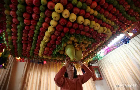 A member of the Samaritan sect decorates a traditional hut known as a sukkot with fruits and vegetables on Mount Gerizim, on the outskirts of the West Bank city of Nablus, October 26, 2015. A sukkot is a ritual hut used...