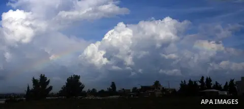 A rainbow shines over Above farmland after heavy rain poured near the border fence between Israel and the central Gaza Strip on October 27, 2015. Israel carried out an air strike against two Hamas targets in the Gaza Str...