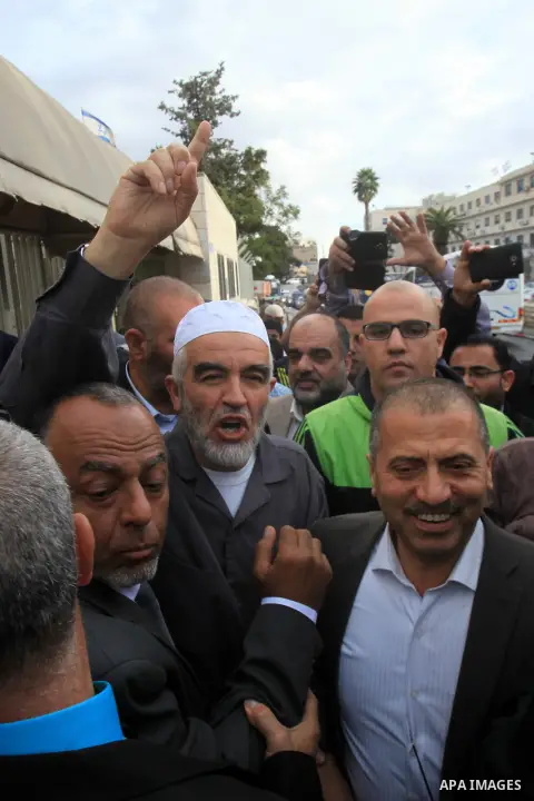 Leader of the radical northern wing of the Islamic Movement in Israel, Sheikh Raed Salah, gestures outside a Jerusalem court after he was convicted on October 27, 2015. An Israeli court upheld a conviction of the firebra...