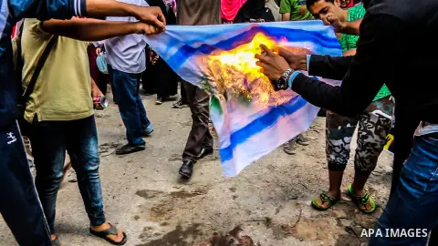 Egyptian protesters burn an Israeli flag during an anti-Israel demonstration in Giza district, near Cairo on October 30, 2015. Since the start of October, violence that has included stabbings as well as clashes between P...