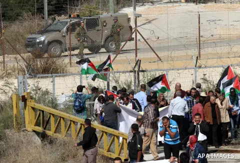 Palestinian protesters argue with Israeli security forces during a demonstration against the expropriation of Palestinian land and the Israeli controversial separation barrier, in the village of Shwaika, near the West Ba...