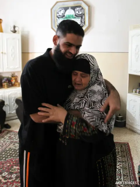 Former Palestinian detainee Mohammed Allan hugs his mother at their house in Nablus in the West Bank on November 5, 2015, after he was released from Israeli jail. Israeli authorities said they had freed Allan, late on No...