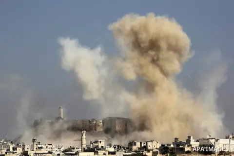 Smoke billows following a reported airstrike by government forces next to the Aleppo Citadel in the northern Syrian city on November 7, 2015. More than 250,000 people have died in Syria's conflict, which several rounds o...