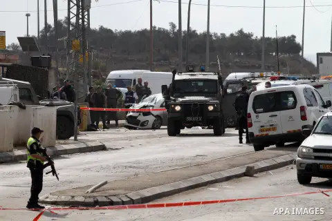 Israeli security forces gather at the scene where a Palestinian man was shot dead by security forces after ramming his car into a group of Israelis at Tapuah junction, south of Nablus in the Israeli-occupied West Bank, o...