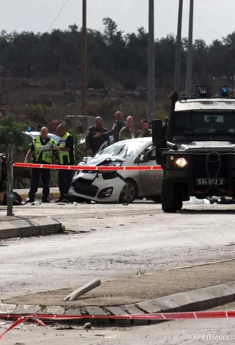 Israeli security forces gather at the scene where a Palestinian man was shot dead by security forces after ramming his car into a group of Israelis at Tapuah junction, south of Nablus in the Israeli-occupied West Bank, o...