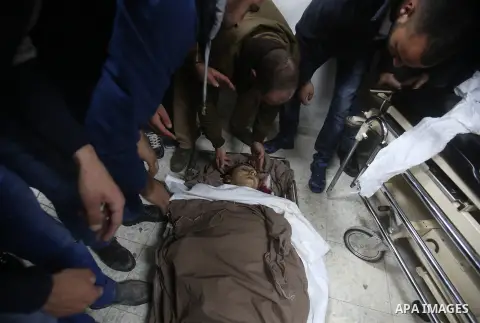 Relatives mourn over the body of Palestinian Shadi Zuhdi Arafah, 28, who was killed by Israeli security forces at the scene of a shooting attack in Gush Etzion settlement, at a hospital morgue in the West Bank city of He...