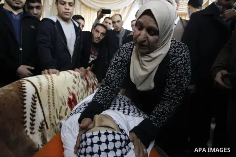 The mother of Shadi Arafa, a 26 year old Palestinian who was reportedly killed near the Jewish settlement bloc of Gush Etzion after an assailant opened fire from a car then crashed into a group of pedestrians, mourn over...
