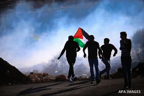 Palestinian protesters take part in clashes with Israeli security forces in Beit El on the outskirts of the West Bank city of Ramallah on November 24, 2015. U.S. Secretary of State John Kerry, scheduled to meet Tuesday w...