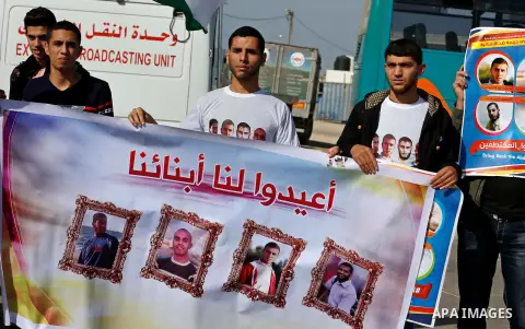 Families of Palestinians who were abducted by gunmen is the northern region of Egypt's Sinai peninsula in August, hold portraits of their loved ones as they take part in a demonstration calling for their release at the R...