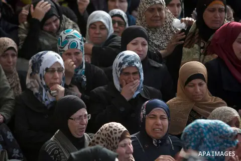Palestinian women mourn during the funeral of 16-year-old Ibrahim Dawood in the West Bank city of Ramallah, Thursday, Nov. 26, 2015. Ibrahim died of his wounds sustained during clashes with Israeli soldiers two weeks ago...