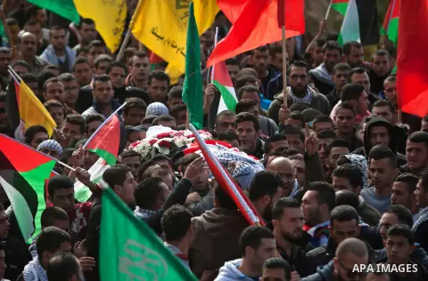 Palestinians carry the body of 16-year-old Ibrahim Dawood during his funeral in the West Bank city of Ramallah, Thursday, Nov. 26, 2015. Ibrahim died of his wounds sustained during clashes with Israeli soldiers two weeks...