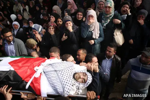 Palestinians carry the body of 16-year-old Ibrahim Dawood during his funeral in the West Bank city of Ramallah, Thursday, Nov. 26, 2015. Ibrahim died of his wounds sustained during clashes with Israeli soldiers two weeks...