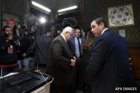 Former acting Egyptian president Adly Mansour, casts his vote at a polling station of the runoff to the second phase of the parliamentary election in Cairo, Egypt, Tuesday, Dec. 1, 2015. Photo by Amr Sayed