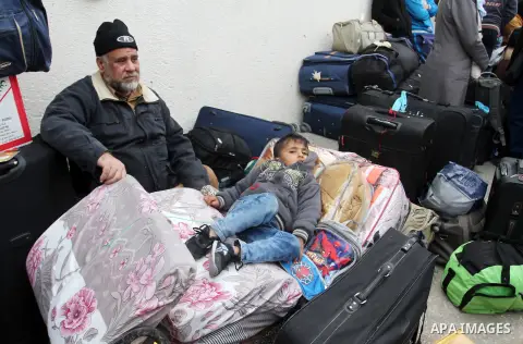 Palestinians wait for travel permits to cross into Egypt at the Rafah border crossing between Egypt and the southern Gaza Strip December 4, 2015. Egypt opened the Rafah border crossing on Thursday for two days to allow P...