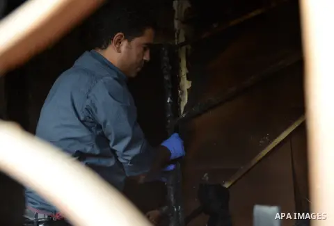 A forensic investigator inspects the scene of a Cairo disco where a petrol bomb attack took place in the Agouza neighbourhood of the Egyptian capital's Giza district on December 4, 2015. At least 16 people were killed an...