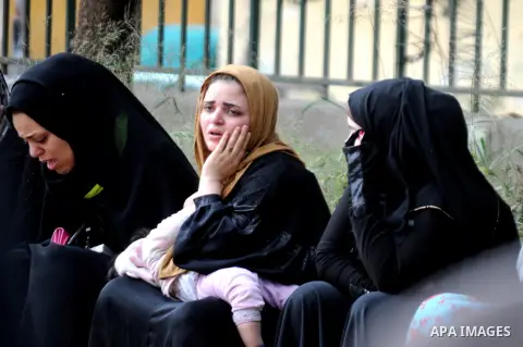 Relatives mourn for victims of a petrol bomb attack on a Cairo disco in the Agouza neighbourhood of the Egyptian capital's Giza district on December 4, 2015. At least 16 people were killed and two wounded in the early mo...