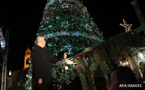 Palestinian Prime Minister, Rami hamdallah, attends the lighting of the Christmas tree on Manger Square, in the West Bank city of Bethlehem, 05 December 2015, as part of the preparations for Christmas. In the background...