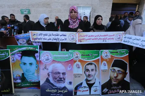 Palestinians take part in a protest demanding release the prisoners in Israeli jails, in front of Red cross office, in Gaza city, on Dec. 07, 2015. Photo by Mohammed Asad