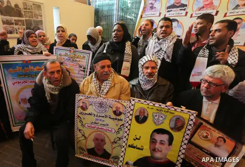 Palestinians take part in a protest demanding release the prisoners in Israeli jails, in front of Red cross office, in Gaza city, on Dec. 07, 2015. Photo by Mohammed Asad