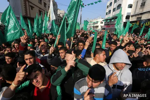 Palestinians attend a military parade of members of al-Qassam Brigades, the armed wing of the Hamas movement, to mark the 28th anniversary of the Islamist movements creation on December 11, 2015, in the Jabalia refugee c...