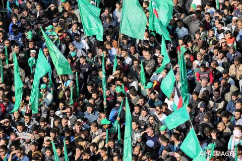 Palestinians attend a military parade of members of al-Qassam Brigades, the armed wing of the Hamas movement, to mark the 28th anniversary of the Islamist movements creation on December 11, 2015, in the Jabalia refugee c...
