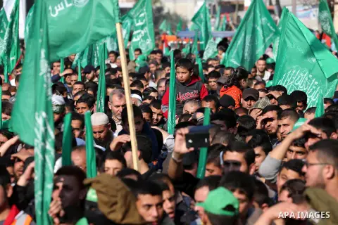 Palestinians attend a military parade of members of al-Qassam Brigades, the armed wing of the Hamas movement, to mark the 28th anniversary of the Islamist movements creation on December 11, 2015, in the Jabalia refugee c...