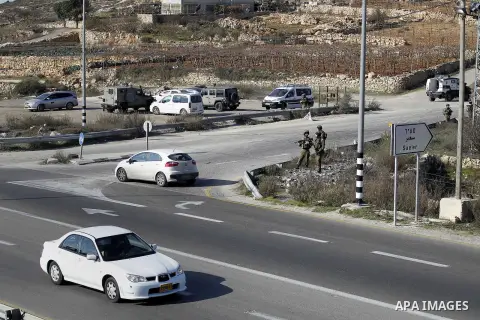 Israeli security forces secure the area after a Palestinian attempted to ram his vehicle into security forces at a military checkpoint on December 11, 2015 at a checkpoint in the West Bank village of Sae'er, near Hebron....