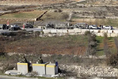 Israeli security forces secure the area after a Palestinian attempted to ram his vehicle into security forces at a military checkpoint on December 11, 2015 at a checkpoint in the West Bank village of Sae'er, near Hebron....