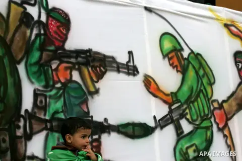 Young Palestinians attend a military parade by members of the Ezzedine al-Qassam Brigades, the armed wing of the Hamas movement, on December 11, 2015, to mark the ruling Islamist movement's 28th birthday in Khan Yunis, i...