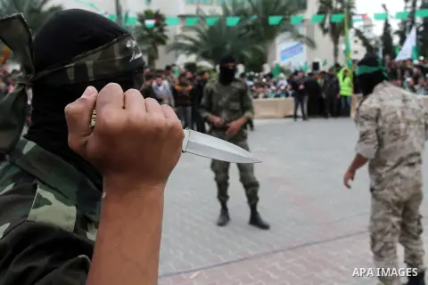 Palestinian militants of the Ezzedine al-Qassam Brigades, the armed wing of the Hamas movement, show their skills during a parade marking the ruling Islamist movement's 28th birthday on December 11, 2015, in Khan Yunis,...