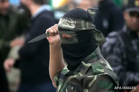 Palestinian militants of the Ezzedine al-Qassam Brigades, the armed wing of the Hamas movement, show their skills during a parade marking the ruling Islamist movement's 28th birthday on December 11, 2015, in Khan Yunis,...