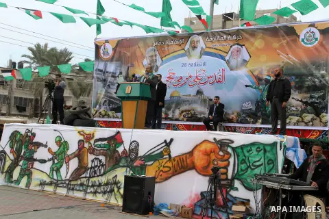 Palestinians attend a military parade by members of the Ezzedine al-Qassam Brigades, the armed wing of the Hamas movement, on December 11, 2015, to mark the ruling Islamist movement's 28th birthday in Khan Yunis, in the...