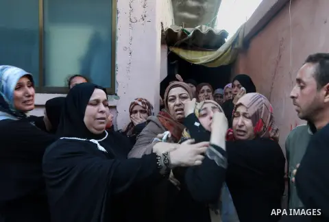 Relatives of Palestinian Sami Madi, who was killed the previous day during clashes with Israeli soldiers on the border fence between the Gaza Strip and Israel, mourn during his funeral in Deir al-Balah, central Gaza, on...