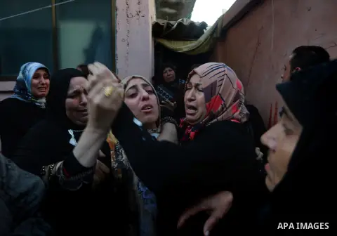 Relatives of Palestinian Sami Madi, who was killed the previous day during clashes with Israeli soldiers on the border fence between the Gaza Strip and Israel, mourn during his funeral in Deir al-Balah, central Gaza, on...