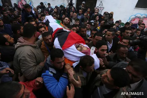Palestinian mourners carry the body of Sami Madi, who was killed the previous day during clashes with Israeli soldiers on the border fence between the Gaza Strip and Israel, during his funeral in Deir al-Balah, central G...