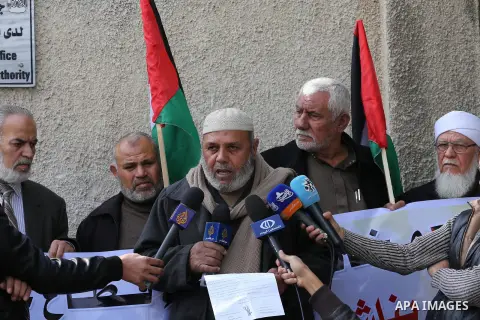 Palestinians hold banners during a protest demanding the Egyptian authorities for the opening of the Rafah crossing in front of the Egyptian embassy, in Gaza city, on Dec. 13, 2015. Photo by Mohammed Asad