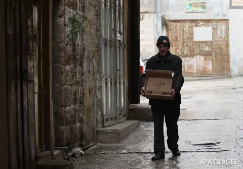 A Palestinian man walks at a street during a rainy day, in the West Bank city of Nablus on Dec. 13, 2015. Photo by Nedal Eshtayah