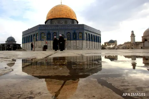 Palestinians walk near Jerusalem's Dome of the Rock mosque in the Al-Aqsa mosque compound, the third holiest site in Islam but also the most sacred place in Judaism, on Dec 13, 2015. Photo by Mahfouz Abu Turk