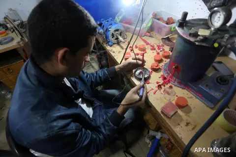 A Palestinian silver jeweler designs silver rings at his workshop in Gaza city on Dec. 16, 2015. Photo by Mohammed Asad